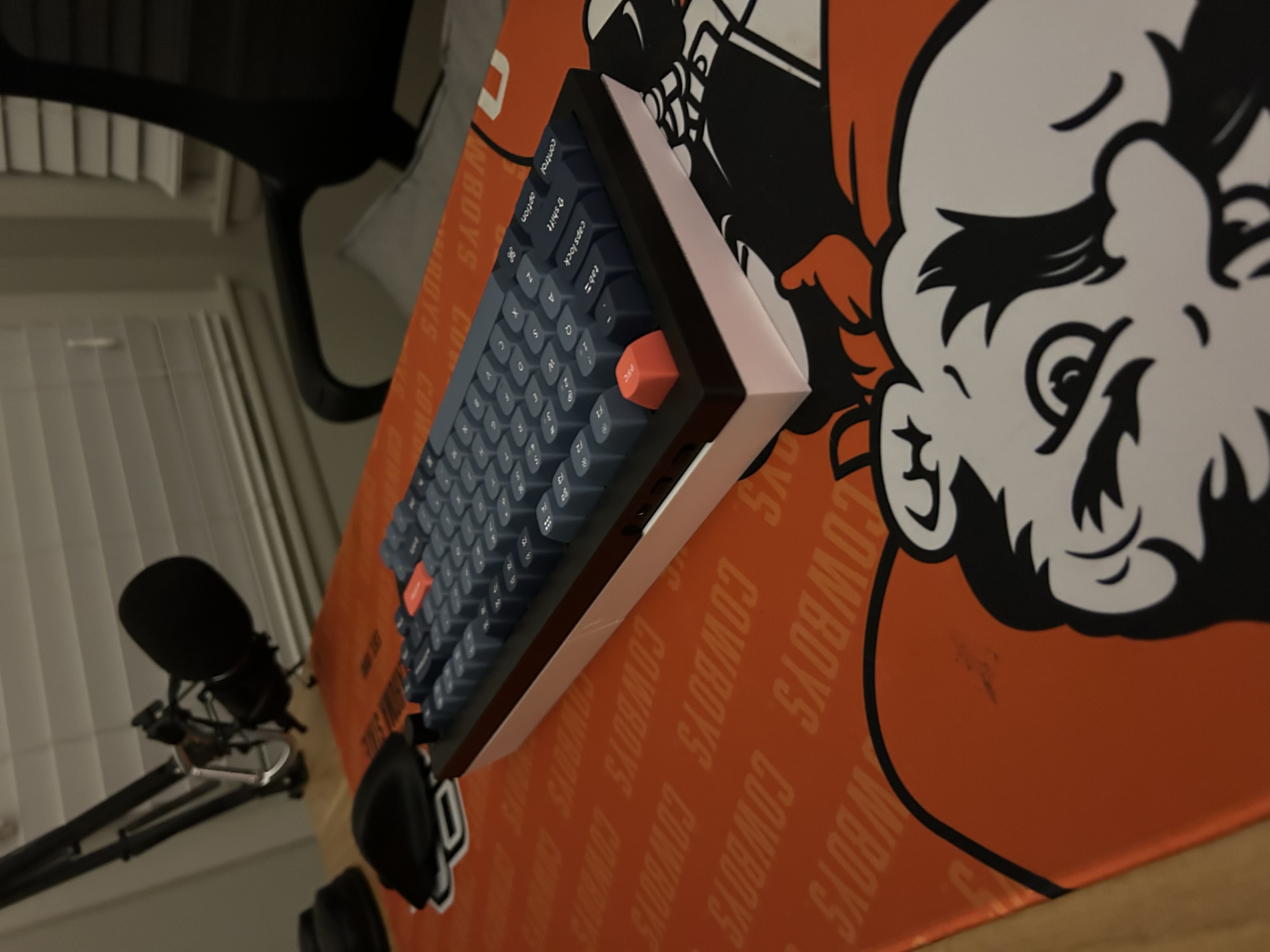 Angled view of the keyboard propped up on the cover pieces stored beneath it